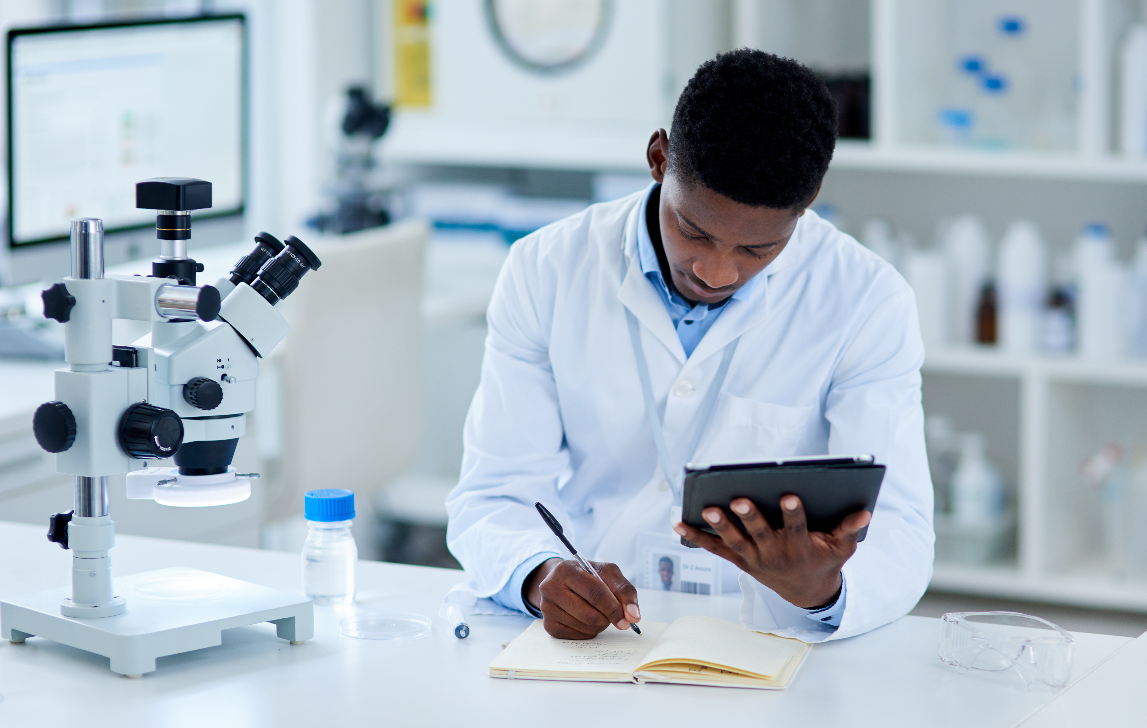 science researcher black man writing tablet notes experiment test scores with connection laboratory african person expert with tech online reading with review feedback